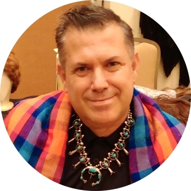 Jose Gutierrez wearing José Sarria's Native American necklace and plaid shawl