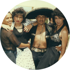 Five Latinx people dressed for the 1991 Orange County Gay Pride Festival