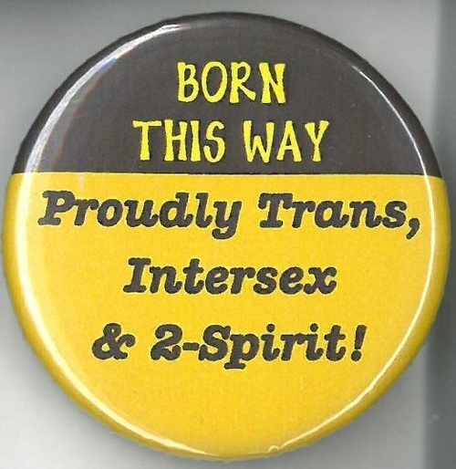 Circular yellow and black button with text of inverted color. This button reads "Born This Way: Proudly Trans, Intersex & 2-Spirit!"
