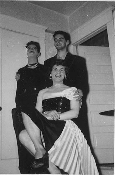 Download the full-sized image of Unknown femme and man standing behind sitting femme in black and white dress