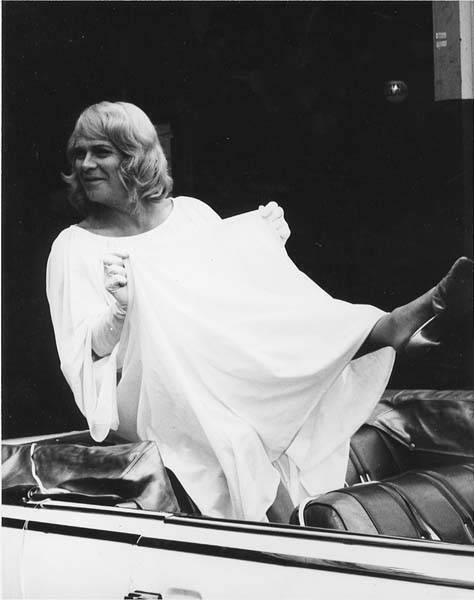 Download the full-sized image of Unknown femme perched in the back of a convertible