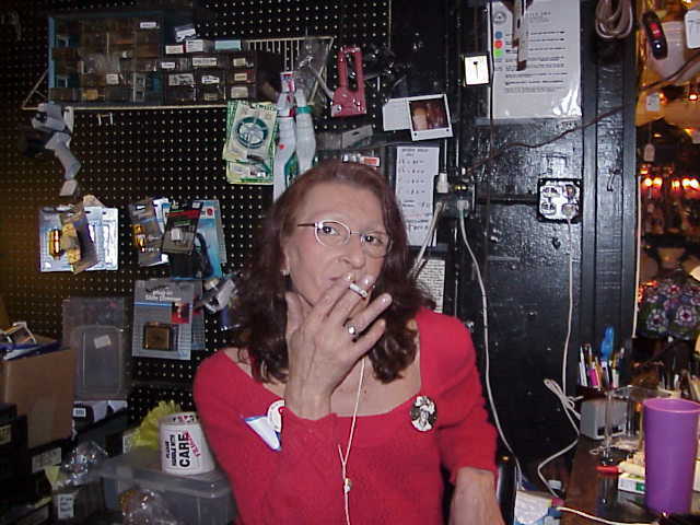 Download the full-sized image of A Photograph of Sylvia Rivera Smoking a Cigarette, Wearing a Red Shirt