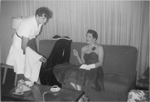 Download the full-sized image of Two unknown femmes trying on clothes at a house party