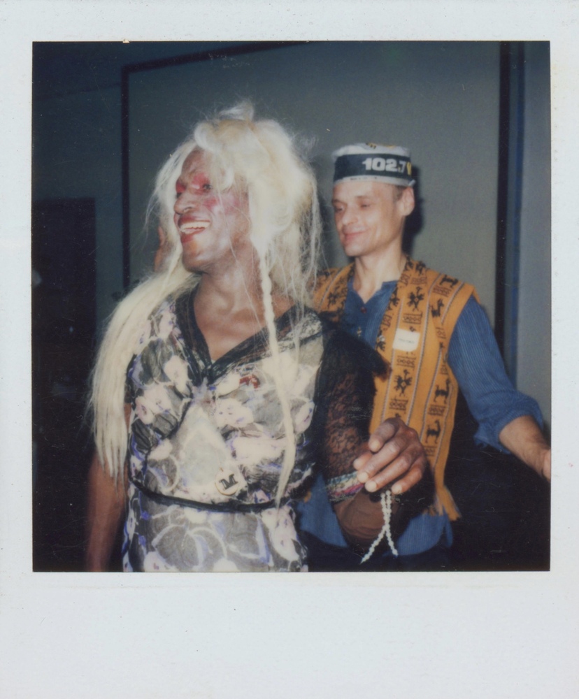 Download the full-sized image of A Photograph of Marsha P. Johnson with Blonde Hair and a Black and Pink Patterned Dress, Dancing with Another Person