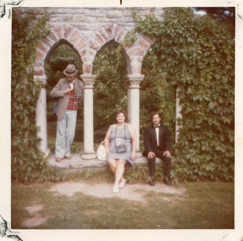 Download the full-sized image of Photograph of Rupert Raj Sitting Under an Arch with Two Others