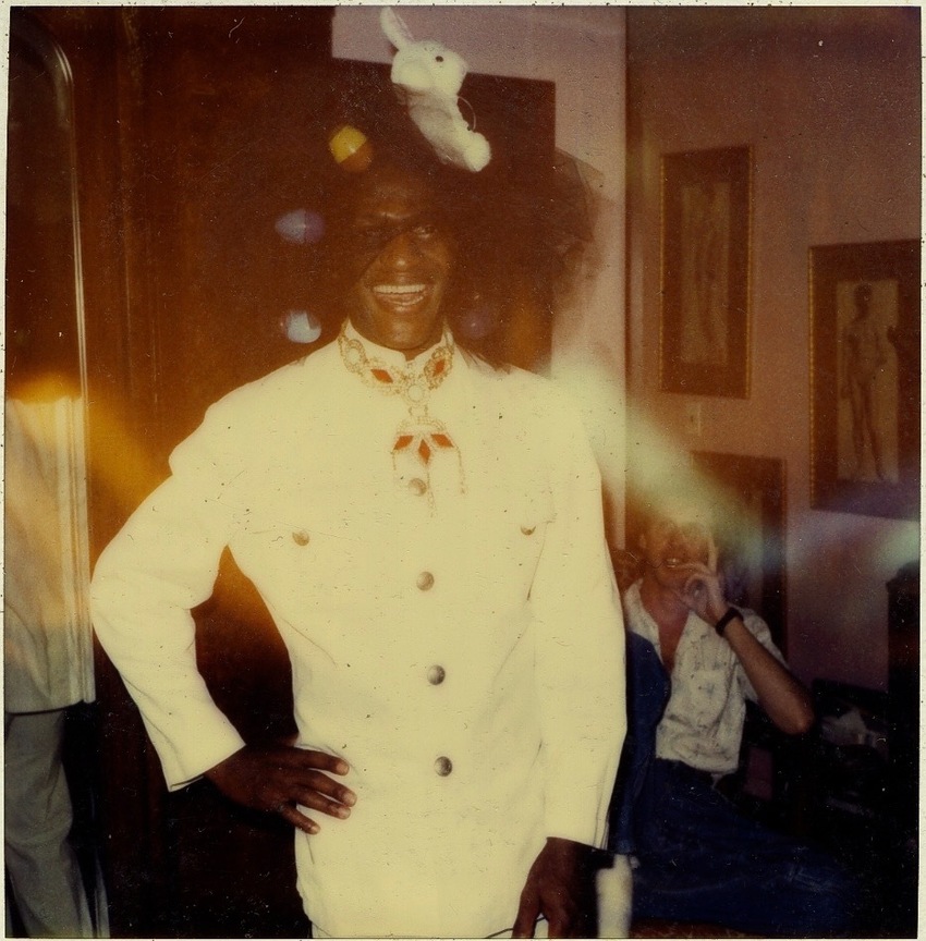 Download the full-sized image of A Photograph of Marsha P. Johnson Wearing a White Outfit and an Easter-themed Headpiece