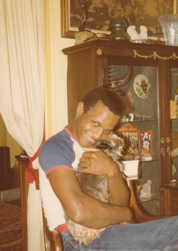 Download the full-sized image of A Photograph of Marsha P. Johnson Hugging a Dog in Her Lap