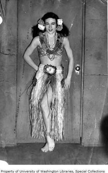 Download the full-sized image of Paris Delaire in grass skirt and floral hairpiece