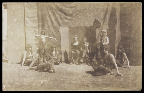 Download the full-sized image of British servicemen in drag playing characters in a play. Photograph, ca. 1918.