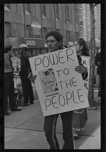 Download the full-sized image of Photograph of Sylvia Rivera Carrying a Sign at Weinstein Hall Demonstration