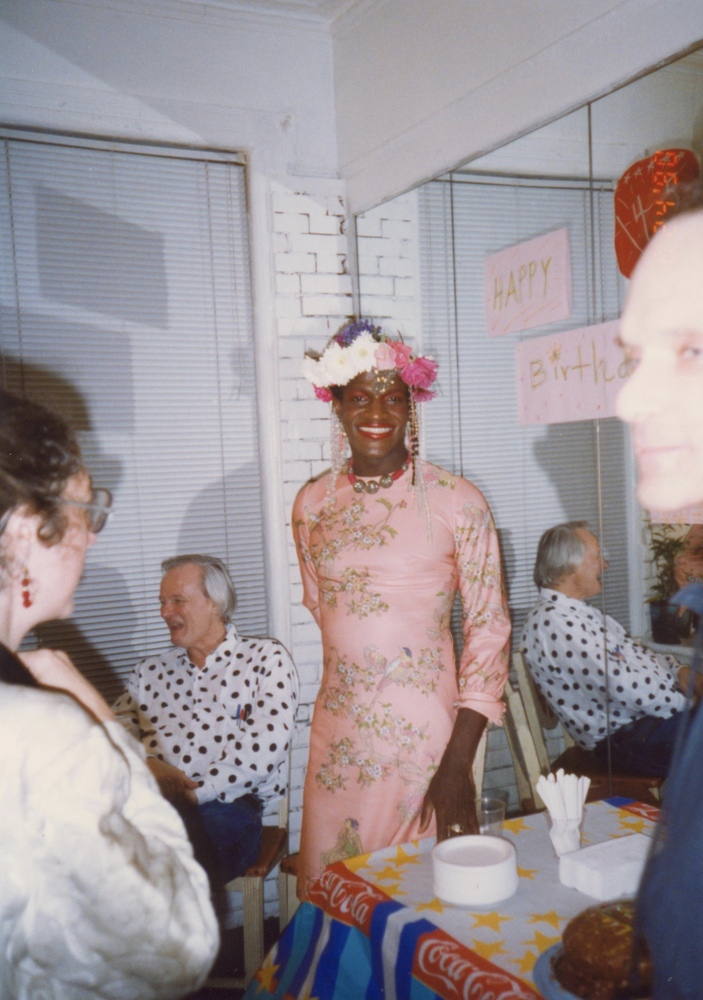 Download the full-sized image of A Photograph of Marsha P. Johnson Posing Standing in Front of a Mirror at Her Birthday Party