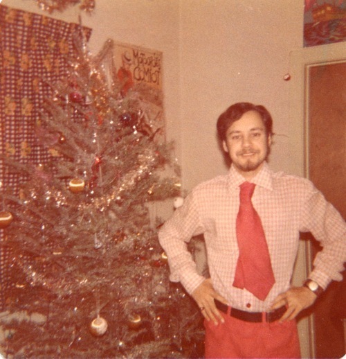 Download the full-sized image of Photograph of Rupert Raj in front of a Christmas Tree