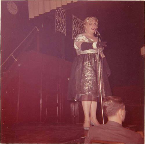 Download the full-sized image of Countess Estelle on stage in front of a microphone