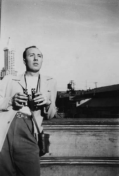 Download the full-sized image of Jackie Starr with binoculars with Smith Tower in the background