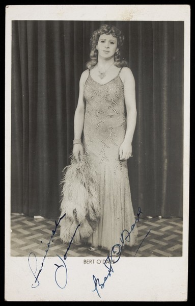 Download the full-sized image of Bert O'Dare in drag, performing on stage. Photographic postcard, 1946.