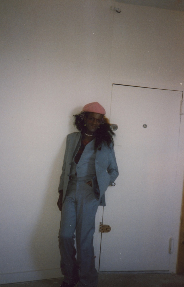 Download the full-sized image of A Photograph of Marsha P. Johnson Wearing a Blue Three-Piece Suit and a Pink Hat