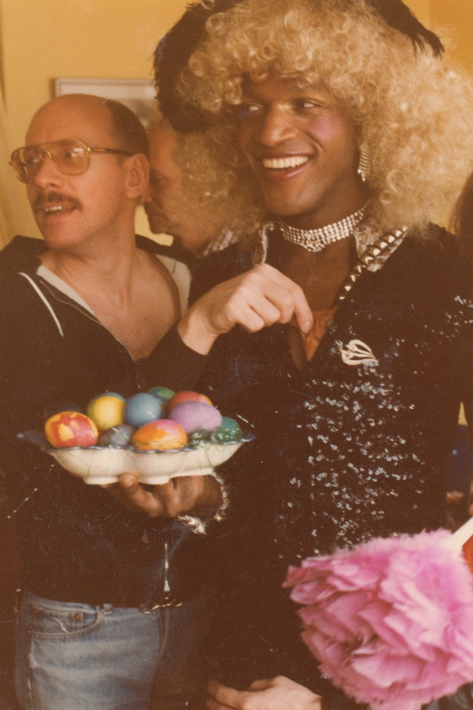 Download the full-sized image of A Photograph of Marsha P. Johnson Holding a Platter of Colorful Easter Eggs with Peter Ogren