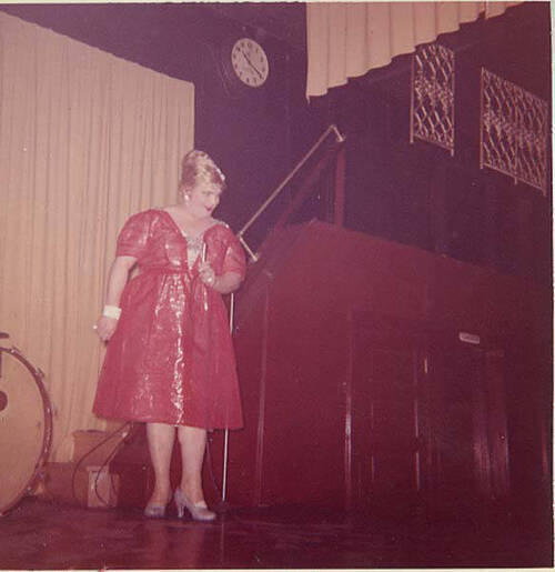 Download the full-sized image of Countess Estelle onstage in red dress