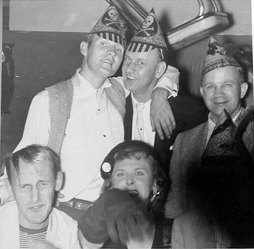 Download the full-sized image of Countess Estelle at a party with five men, most in party hats.