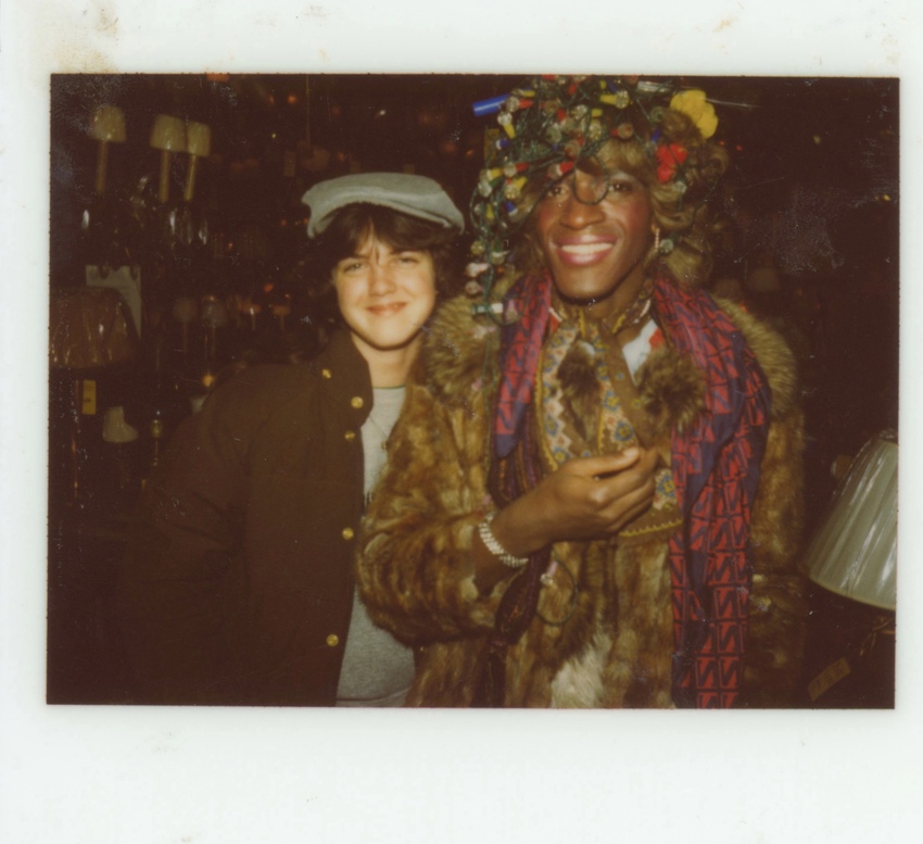 Download the full-sized image of A Photograph of Marsha P. Johnson Wearing a Christmas Lights Headpiece and a Fur Coat, Posing with Another Person at Uplift Lighting