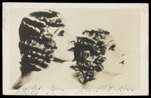 Download the full-sized image of Bartlett and Ross in drag pose in profile, with matching hair and make-up. Photographic postcard, 1937/1938.