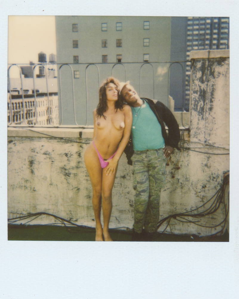 Download the full-sized image of A Photograph of Marsha P. Johnson Posing Next to a Nude Model on a Rooftop